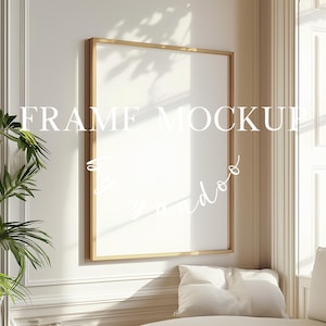 May include: A gold picture frame mockup with a white background. The frame is hanging on a white wall with white trim. There is a plant in the corner of the image.