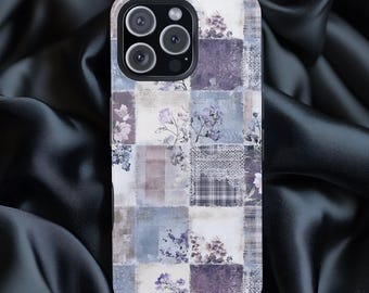 May include: A phone case with a patchwork design featuring floral and geometric patterns in shades of purple, blue, and white. The case has a glossy finish and a camera cutout.
