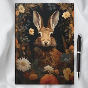 May include: A brown rabbit with large ears sits in a wreath of flowers. The rabbit has a soft, furry coat and looks directly at the viewer. The flowers are a variety of colors, including white, yellow, orange, and red.