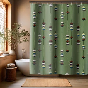 May include: Green shower curtain with a repeating pattern of geometric shapes in various colors, including white, brown, and blue. The curtain hangs in a bathroom with a white bathtub and a woven rug.