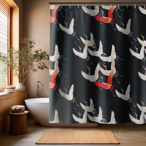 May include: Black shower curtain with a white crane pattern. The cranes are flying in a flock and have red accents. The background is a dark gray color.