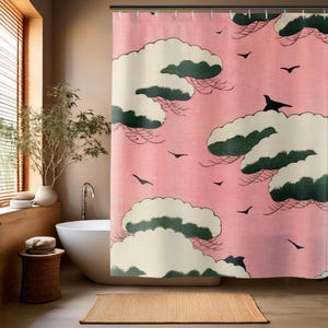 May include: Pink shower curtain with a Japanese-inspired design featuring white clouds with green trees and black birds flying across the sky.