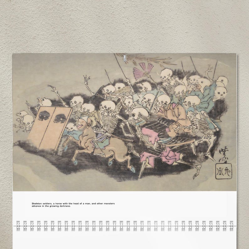 May include: A calendar featuring a Japanese-style illustration of skeleton soldiers, a horse with a human head, and other monsters. The artwork is in shades of gray, blue, pink, and beige, with the text "Skeleton soldiers, a horse with the head of a man, and other monsters advance in the growing darkness."