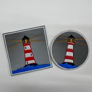 May include: Two embroidered patches featuring a lighthouse design. One patch is square, the other is round. Both patches depict a red and white striped lighthouse with a black top, emitting yellow light beams, set against a gray background with blue waves.