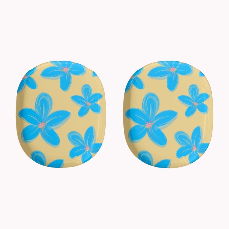 May include: Two oval-shaped earrings with a light yellow background and a repeating pattern of blue flowers with pink centers. The earrings are a fun and colorful accessory.