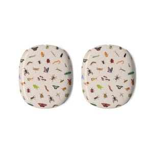 May include: Two oval-shaped decorative items with a beige background, covered in a pattern of various insects. The insects include butterflies, beetles, spiders, and dragonflies in a variety of colors, such as green, orange, and purple.