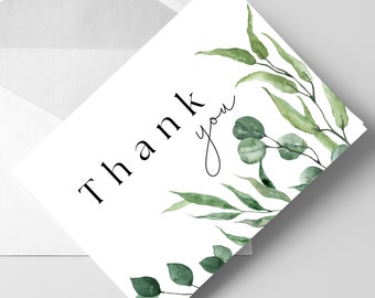 May include: A white card with the text "Thank you" in black lettering. The card is decorated with green watercolor leaves and branches.