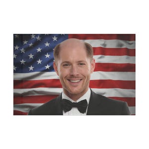 May include: A canvas print featuring a smiling person in a tuxedo with a black bow tie, set against a backdrop of the American flag. The flag's red and white stripes and blue field with white stars are clearly visible.