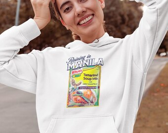 May include: White hoodie with a graphic of a Knorr Tamarind Soup Mix packet and the text "Raining in Manila".