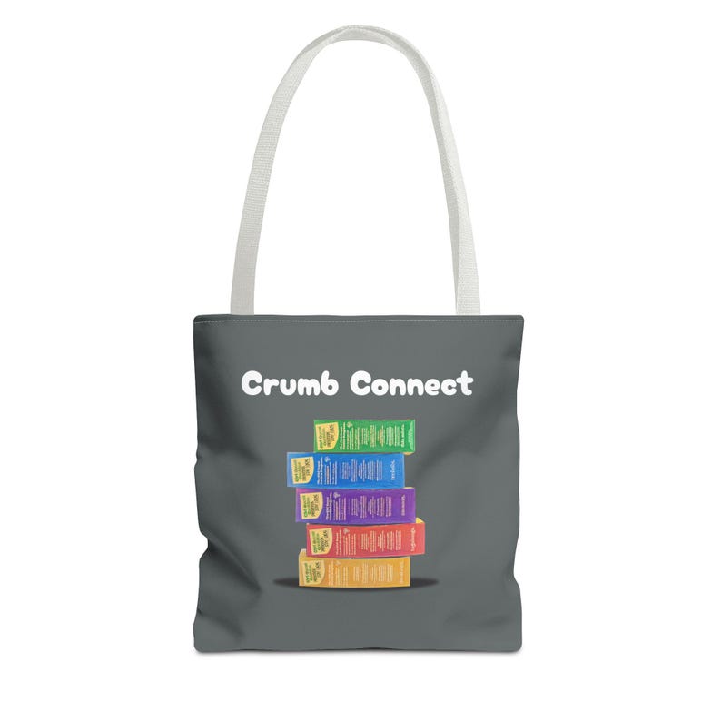 May include: A gray tote bag with white handles and the text "Crumb Connect" printed in white. A stack of colorful boxes with the text "BigCrumb" printed on them is centered on the bag.