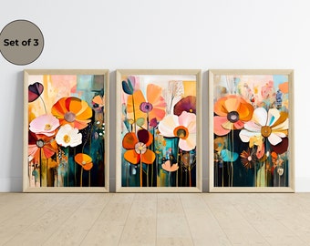 Può includere: Set di tre stampe d'arte floreale astratte in stile moderno. Le stampe presentano un mix di colori di fiori arancioni, rosa, bianchi e blu su uno sfondo scuro.