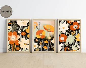 Può includere: Set di tre stampe incorniciate con motivi floreali astratti in tonalità di arancione, giallo, bianco e verde su sfondo nero.