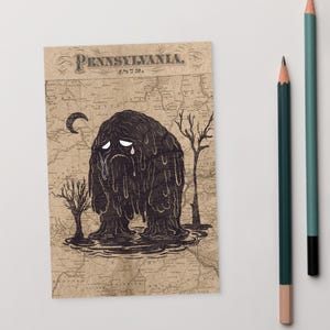 May include: Illustration of a crying, blob-like creature with dripping features, set against a vintage map of Pennsylvania. The artwork includes a crescent moon and bare trees. The text "Pennsylvania, 1873" is at the top. Two pencils are on the right.