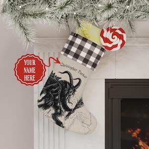 May include: A beige Christmas stocking featuring a black and white illustration of Krampus with horns and a basket, topped with a black and white buffalo check cuff. The name Christopher Parker is printed in black script on the stocking.