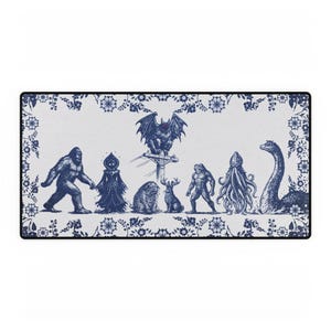 May include: A rectangular mousepad featuring a blue and white illustration of various cryptids, including Bigfoot, a bat-like creature, and the Loch Ness Monster. The design is framed by a floral border.
