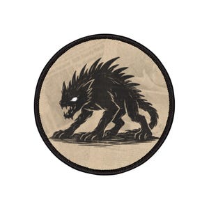 May include: A circular patch featuring a black, stylized illustration of a snarling wolf-like creature with glowing white eyes. The patch has a tan background and a black border.