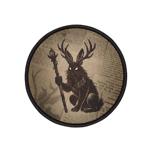 May include: A circular patch depicting a dark rabbit with antlers, holding a staff with a flame. The rabbit has glowing eyes and is set against a newspaper background. The patch has a black border.