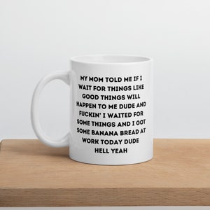 May include: White ceramic coffee mug with black text that reads: "MY MOM TOLD ME IF I WAIT FOR THINGS LIKE GOOD THINGS WILL HAPPEN TO ME DUDE AND FUCKIN' I WAITED FOR SOME THINGS AND I GOT SOME BANANA BREAD AT WORK TODAY DUDE HELL YEAH"