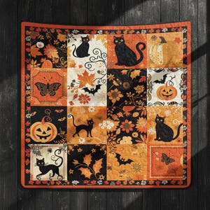 May include: A square quilt featuring a patchwork design with black cats, orange pumpkins, bats, butterflies, and autumn leaves in shades of orange, yellow, and black. The pattern includes various floral and botanical motifs across the grid.