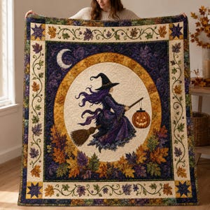 May include: A rectangular quilt featuring a central oval panel with a witch in a purple dress flying on a broomstick while carrying a jack-o'-lantern. The design includes a crescent moon, a dark purple background, and a border of autumn leaves.
