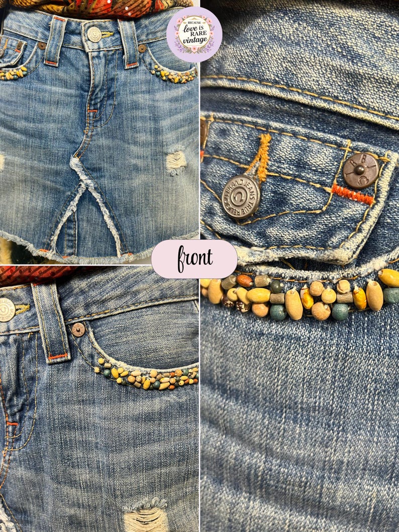 May include: Light blue denim skirt with distressed details. The skirt features decorative beading along the pockets and waistband. The front of the skirt has a split design. The True Religion Jeans logo is visible on the button.
