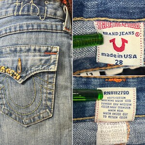 May include: Close-up of a light blue denim skirt with embroidered details and a frayed hem. The back pocket features decorative beading. The label reads "BRAND JEANS" and "made in USA 28".