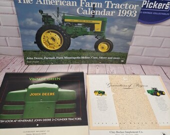 May include: Three vintage John Deere calendars. The top calendar is titled "The American Farm Tractor Calendar 1993" and features a green and yellow tractor. The second calendar is titled "Vintage Green" with a John Deere logo. The third calendar is titled "Generations of Progress".