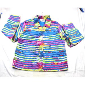 May include: A long-sleeve button-down shirt featuring a vibrant horizontal striped pattern in shades of blue, yellow, pink, and green. The garment has a textured, ruffled surface design and includes a collar with a label reading Karen Hart.