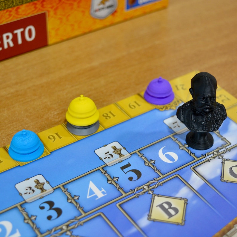 May include: A board game with a blue and yellow game board. The game pieces include a black bust, and blue, yellow, and purple cone-shaped pieces. The numbers 3, 4, 5, and 6 are visible on the board.