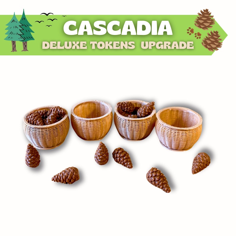 Puede incluir: Se muestran cuatro cestas tejidas, algunas llenas de pi&ntilde;as marrones, con pi&ntilde;as adicionales esparcidas. La imagen incluye el texto "Cascadia Deluxe Tokens Upgrade" en verde y blanco.