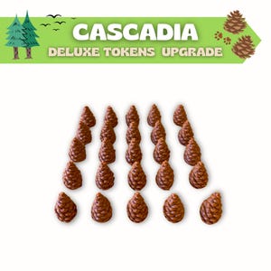 Puede incluir: Una colecci&oacute;n de fichas de pi&ntilde;as marrones para el juego de mesa Cascadia. Las fichas est&aacute;n dispuestas sobre un fondo blanco. La parte superior de la imagen tiene el texto "Cascadia Deluxe Tokens Upgrade" con una pancarta verde e ilustraciones de &aacute;rboles y pi&ntilde;as.