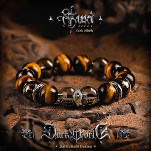 May include: A beaded bracelet featuring tiger's eye and dark brown beads. The bracelet includes silver-toned metal accents and is set against a textured, brown background. The image includes the text "Suki Dark World" and "Dark World Battlefield Series."
