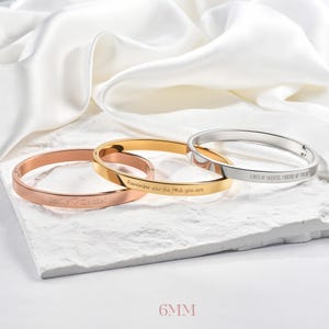 May include: Three engraved bangles in rose gold, gold, and silver. The rose gold bangle reads "Emily &hearts; Daniel", the gold bangle says "Remember who the f*ck you are", and the silver bangle says "ALWAYS MY DAUGHTER, FOREVER MY FRIEND". The bangles are 6mm wide.