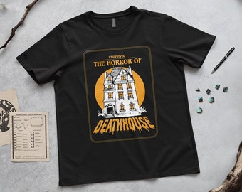 May include: Black t-shirt with a graphic of a haunted house and the text "I survived the horror of Deathhouse".