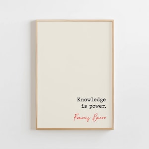 May include: A framed print with a light beige background. The text "Knowledge is power" is printed in black, with "Francis Bacon" in red cursive below. The frame is a light wood color.
