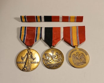 May include: Three gold-colored military medals with colorful ribbons. The medals include "World War II", "Occupation Service", and "National Defense". A matching ribbon bar is above the medals.