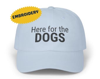 May include: Light blue baseball cap with black embroidered text that reads "Here for the DOGS".