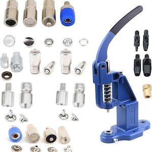 May include: A blue and black snap fastener machine with various metal and blue components. The set includes a variety of metal snap fasteners and tools for attaching them. The machine has a lever and spring mechanism.