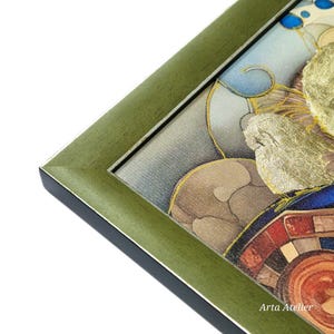 May include: A close-up of a green frame surrounding a colorful artwork. The artwork features gold leaf accents and a blue and white background. The text "Arta Atelier" is visible in the bottom right corner.