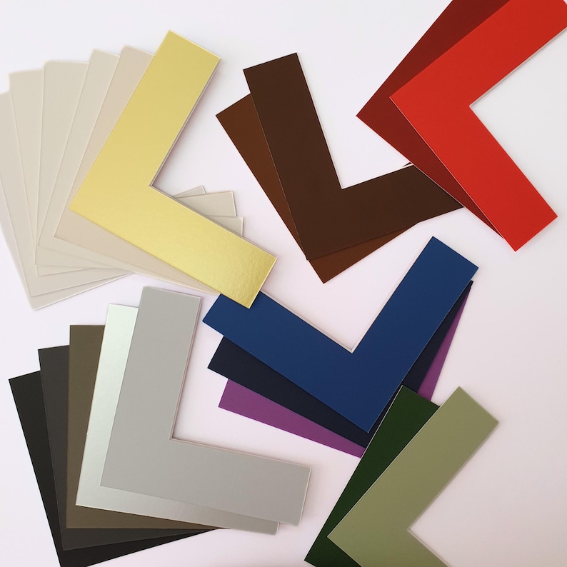 May include: Assortment of 10 different colored mat boards in the shape of an L. The colors are gold, brown, red, blue, navy, purple, green, gray, black, and beige.