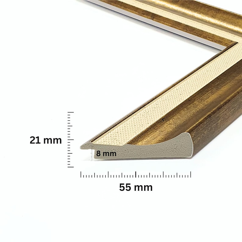 May include: A gold picture frame with a white inner edge. The frame is 21 mm wide, 8 mm thick, and 55 mm long.