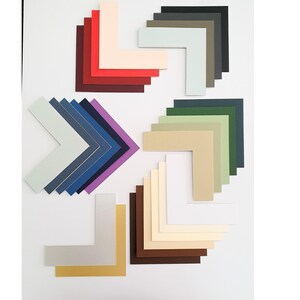 May include: Assortment of colored mat boards in various shades of red, purple, blue, green, beige, brown, and white. The mat boards are cut in a corner shape.