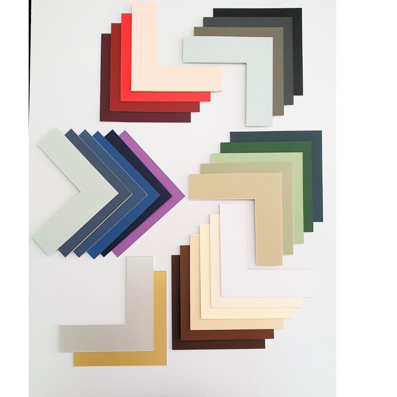 May include: Assortment of colored mat boards in various shades of red, purple, blue, green, beige, brown, and white. The mat boards are cut in a corner shape.
