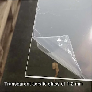 May include: A clear acrylic sheet with a protective film partially peeled back. The sheet is 1-2 mm thick.