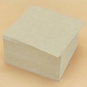 May include: A stack of beige, rectangular paper sheets. The paper has a slightly textured surface and a natural, earthy tone. The sheets are neatly stacked, suggesting they are ready for use. The edges of the paper are slightly rounded.