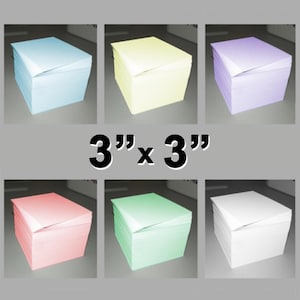 May include: Six stacks of 3" x 3" colored paper squares. The colors are light blue, yellow, lavender, pink, green, and white.
