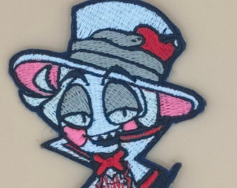 May include: Embroidered iron-on patch featuring a cartoon character with a top hat, bow tie, and a red heart on the hat. The character has a white face, gray eyes, and pink ears. The patch is on a beige background.