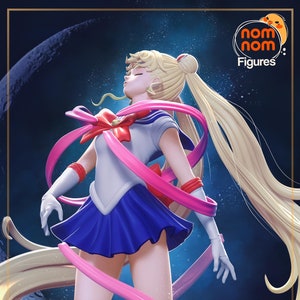 May include: A detailed figurine of a character with long blonde hair, wearing a white and blue sailor uniform with a red bow. Pink ribbons and flowing hair surround the figure against a dark blue background. The figure is from Nom Nom Figures.