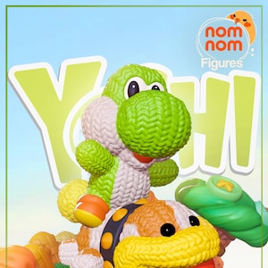 May include: A green Yoshi and a brown Bowser plush toy, both knitted, sitting on a green leaf with buttons. The plush toys are part of the "Nom Nom Figures" collection.