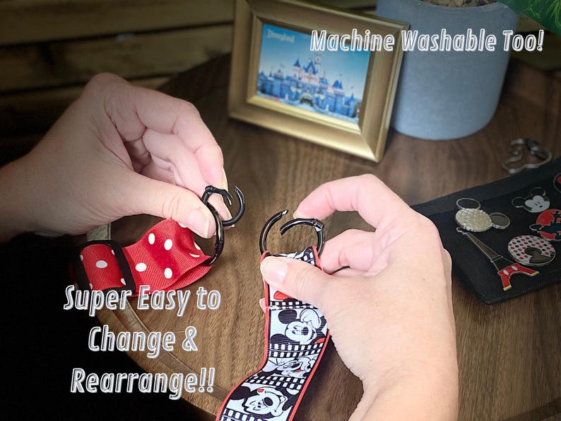 May include: Two hands are shown connecting a black metal clasp to a red and white polka dot ribbon and a black and white Mickey Mouse ribbon. The text "Super Easy to Change & Rearrange!!" is visible.